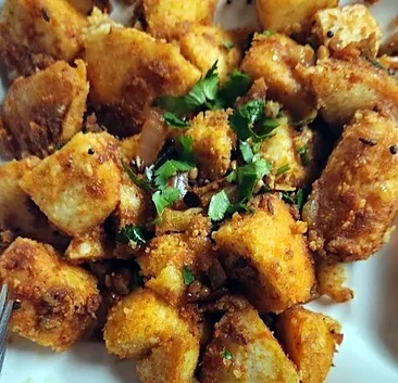 Ghee podi idly pieces tossed in spice powder with coriander